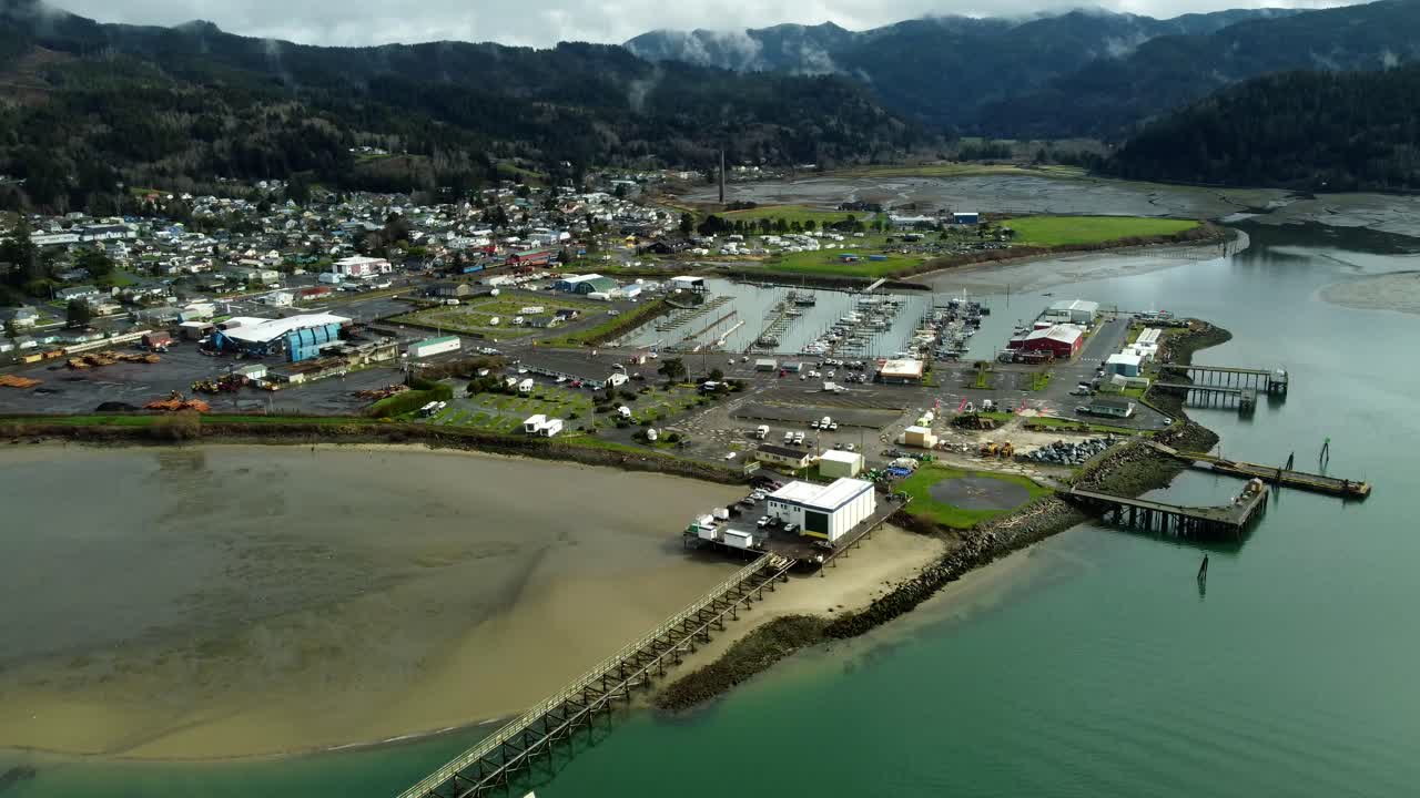 US, Oregon, Garabaldi, , 2025-03-18 - Drone view of the city, the marina, and the mountains. The foreground is the historic Coast Guard Lifeboat Launch, and the center one is the modern Coast Guard