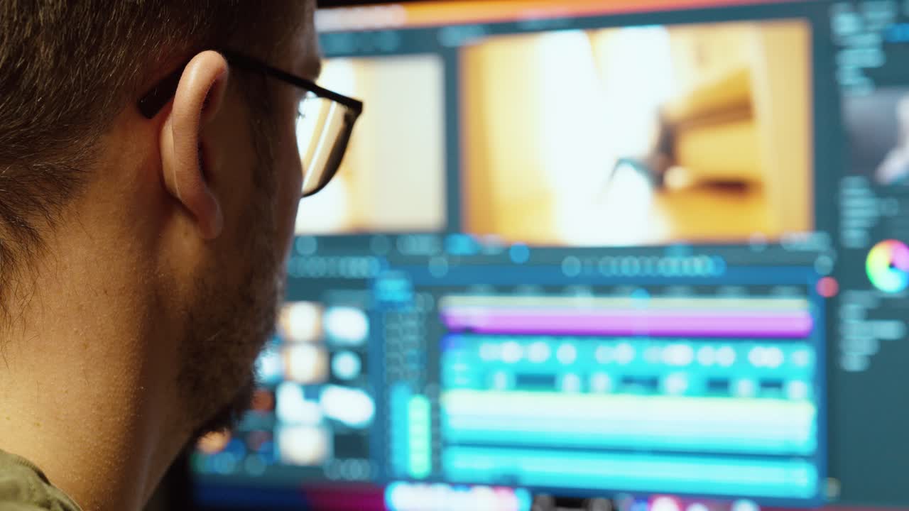 A video editor works on color grading in a professional editing software. Concept of film production, post-processing, and creative workflow in media industry