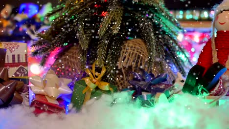 sliding close-up of a christmas tree with presents under it