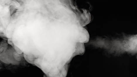 smoke shoots to the left and right while billowing towards camera in the center