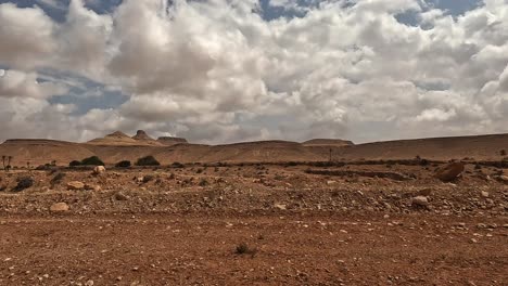 driving along desert road to ksar guermessa troglodyte village in tunisia on cloudy day