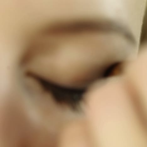 woman applying eyeshadow
