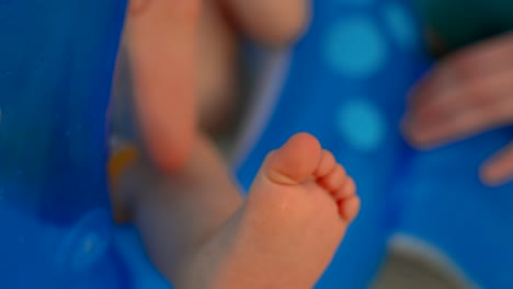 primer plano del talón de un niño pequeño que sobresale de un juguete inflable de goma