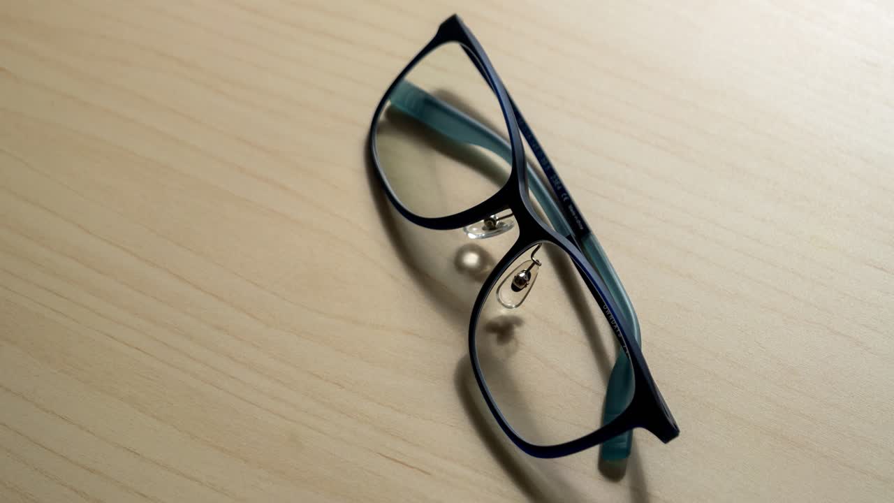 Explore the sleek design of stylish glasses captured in a serene home office setting.