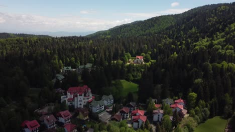 dracula's domain from above: aerial 4k drone shot showcasing 'house of dracula' at poiana brasov ski resort in carpathian mountains