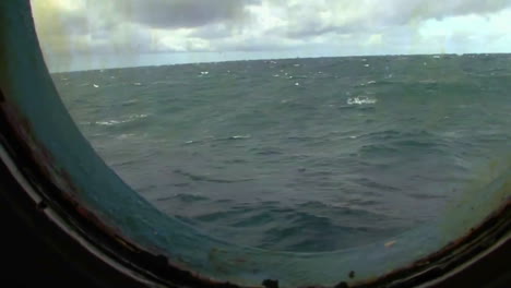 A-view-through-a-ship\'s-porthole-on-the-high-seas