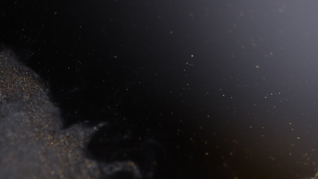 A wave of black ink sweeping across like a tsunami. Macro view