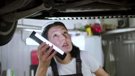 woman inspecting automobile