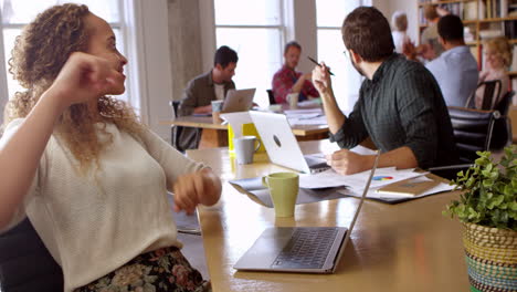 businesswoman dancing at desk in office shot on r3d