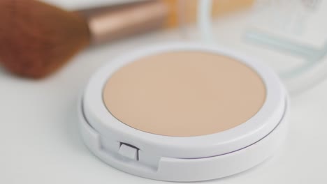 compact face powder and brush