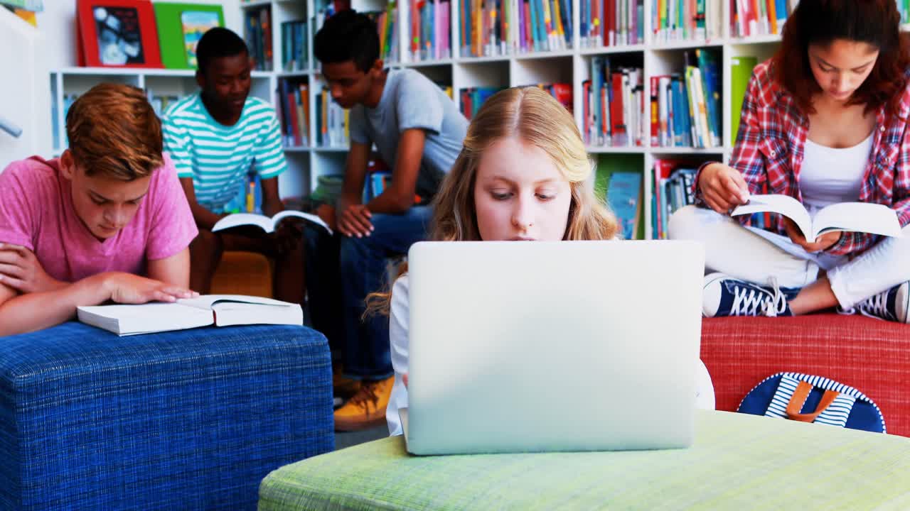 School kids doing homework in library