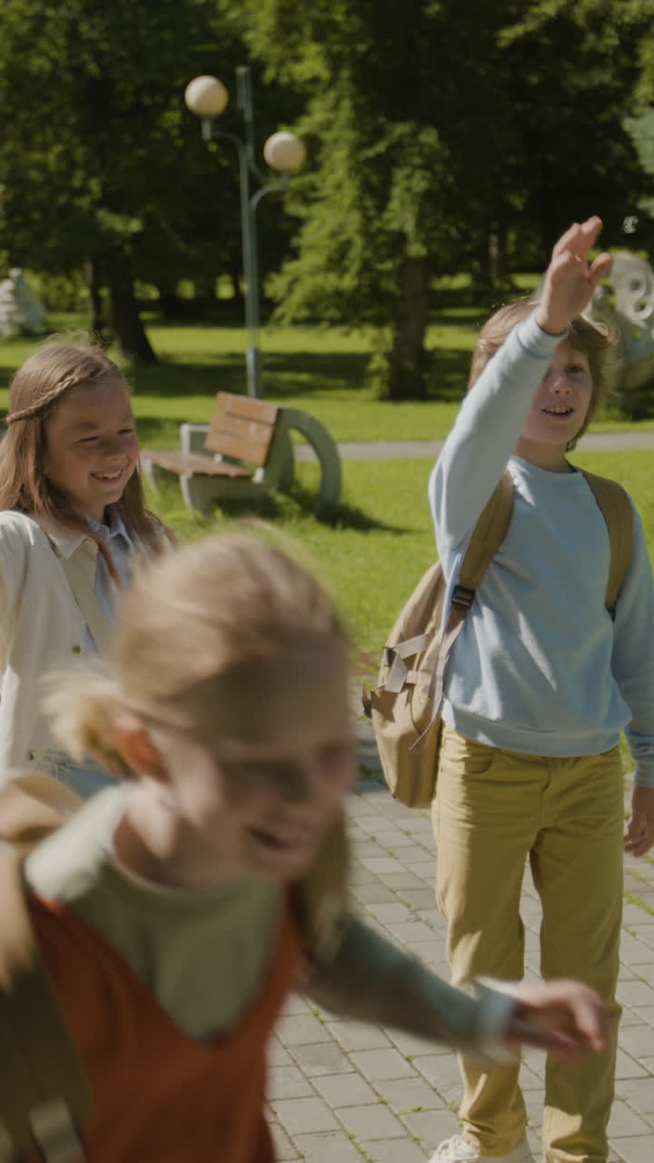 Two happy children walking together in a park