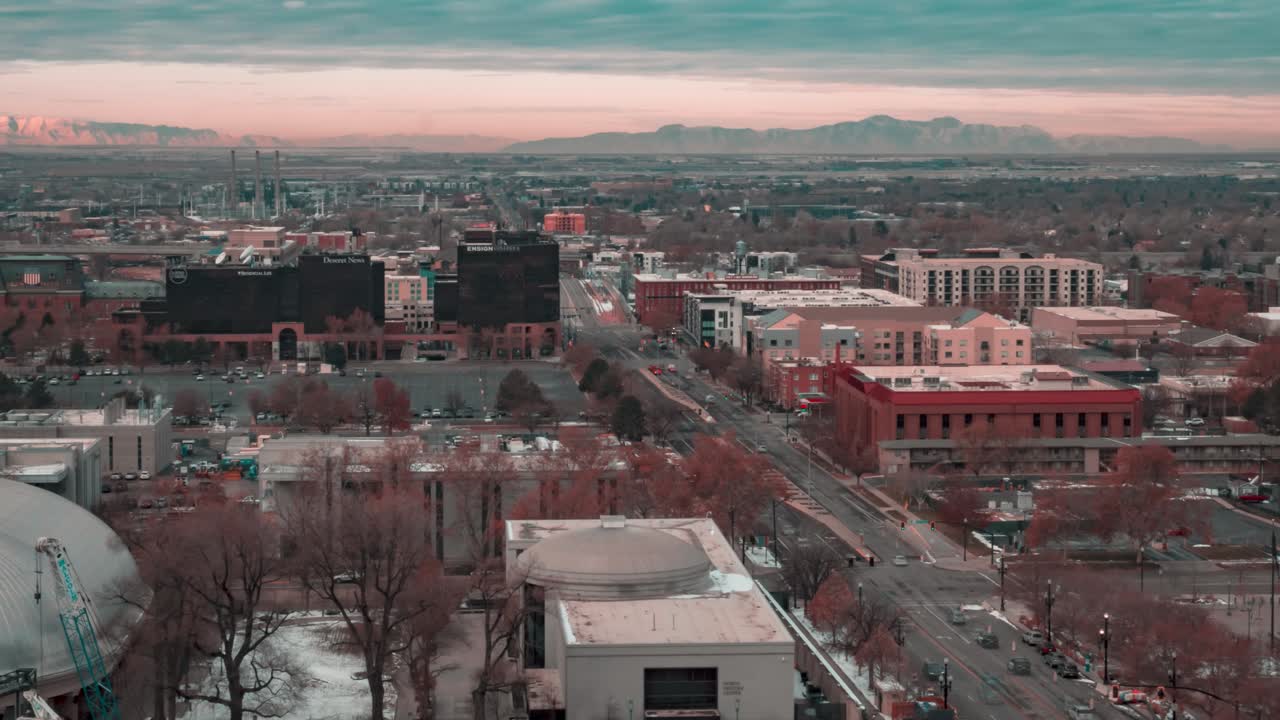 el tráfico se mueve a lo largo de una calle del centro de salt lake city mientras las nubes pasan por encima en este lapso de tiempo urbano tomado desde una azotea