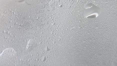 drops of steam from hot water on misted glass