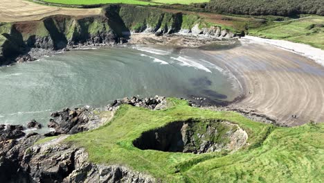 drone static view of the large blowhole at kilmurrin cove copper coast waterford ireland one of the wonders of nature