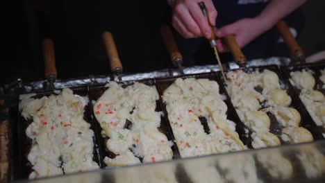 japanese takoyaki, octopus dumplings being cooked on streets of osaka