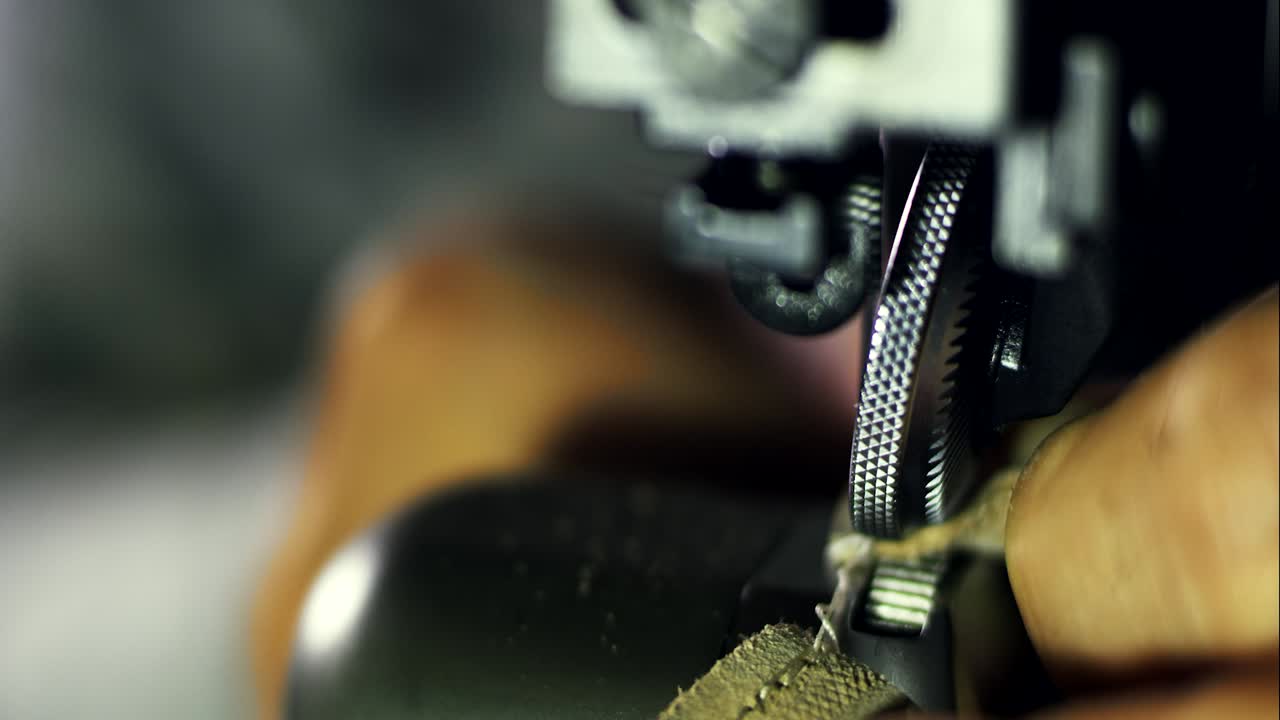 Handicraftsman hand manufacturing. Close up sewing machine mechanism in work