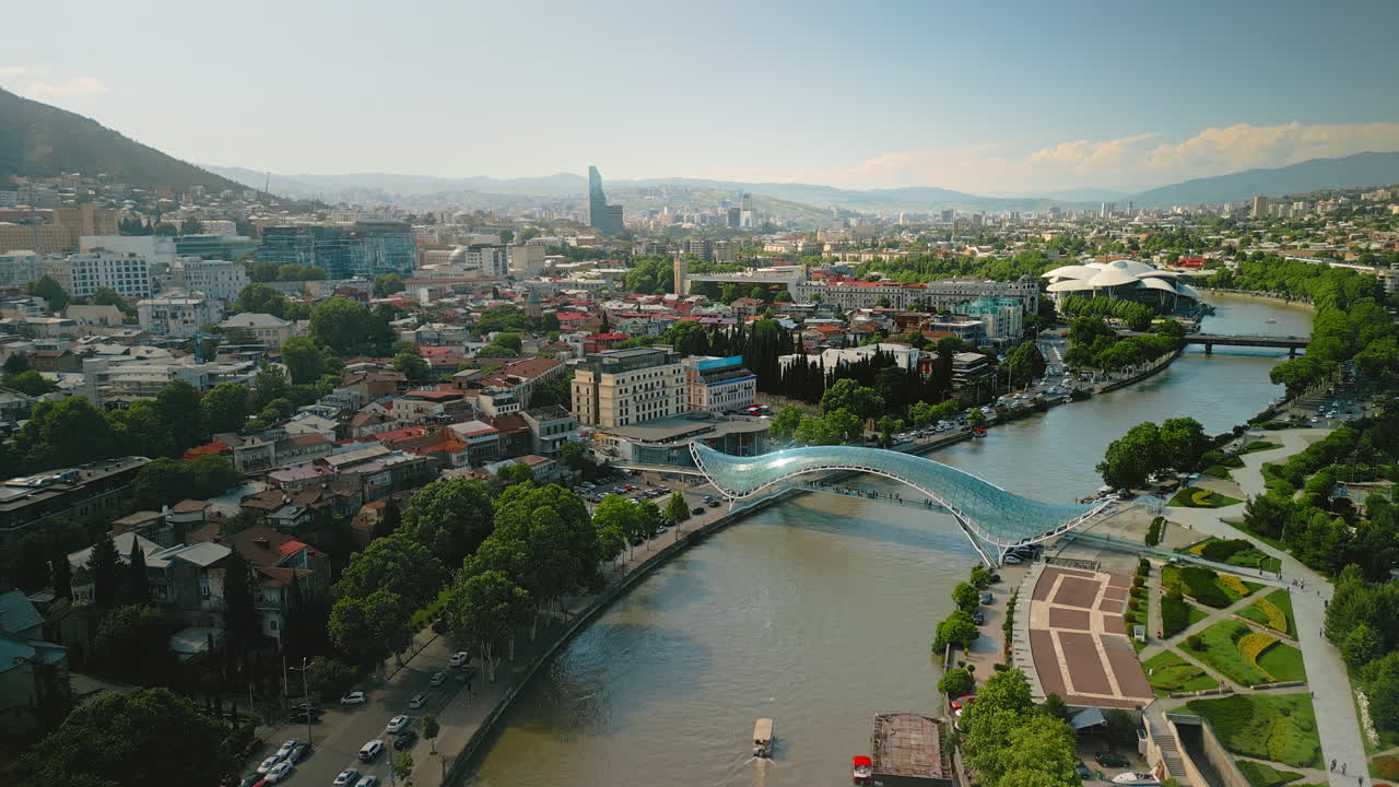 Aerial View of Tbilisi, Georgia, Showcasing the Kura River and Peace Bridge
