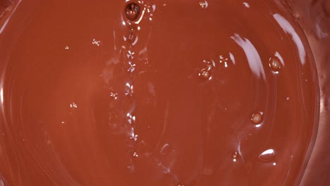 smooth chocolate liquid pouring and rippling