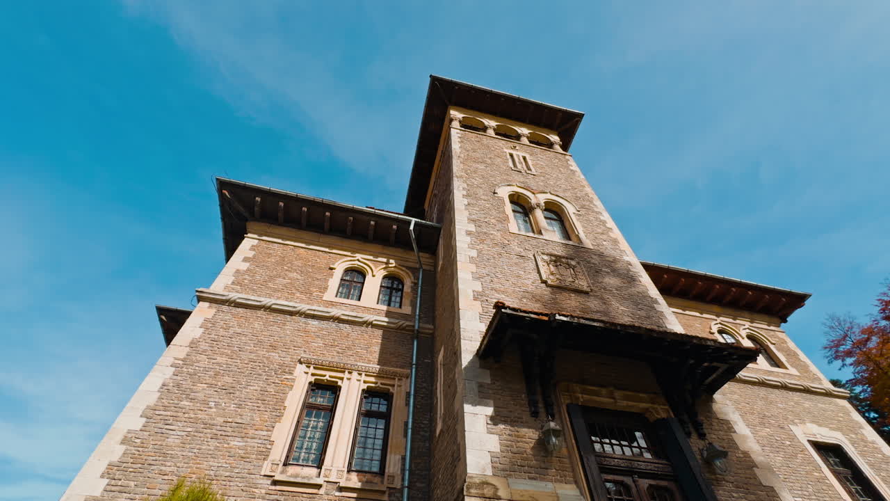 Entrance to Cantacuzino Castle in Busteni, Romania. Beautiful old building façade on sunny autumn day. Low angle view.