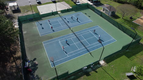 Rotating-drone-shot-of-people-playing-Pickelball