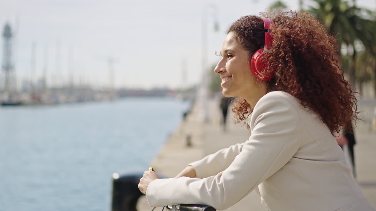 Woman with headphones by the sea