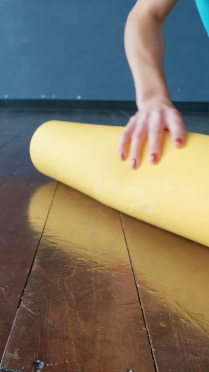 Close-up of a person's foot in motion on a blue yoga mat, showcasing flexibility and balance during a fitness routine or exercise session