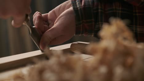 Carpenter-working-with-pouch-in-moody-workshop