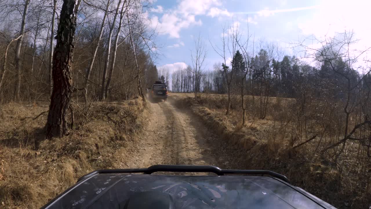 4x4 vehicles driving in forest, mud, empty dust fields - window POV