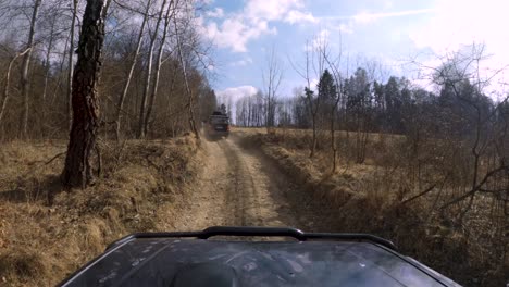 4x4 vehicles driving in forest, mud, empty dust fields - window pov
