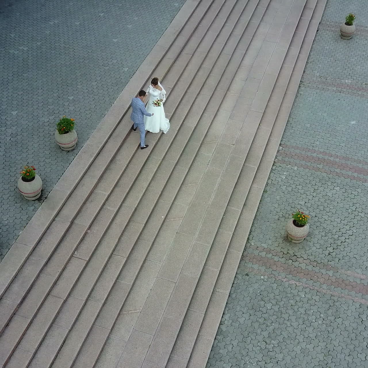 Aerial view. Just married couple walking in the city. Beautiful bridal couple Square video