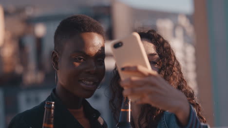 beautiful young women friends taking selfie photo using smartphone enjoying rooftop party sharing weekend lifestyle on social media having fun celebrating friendship