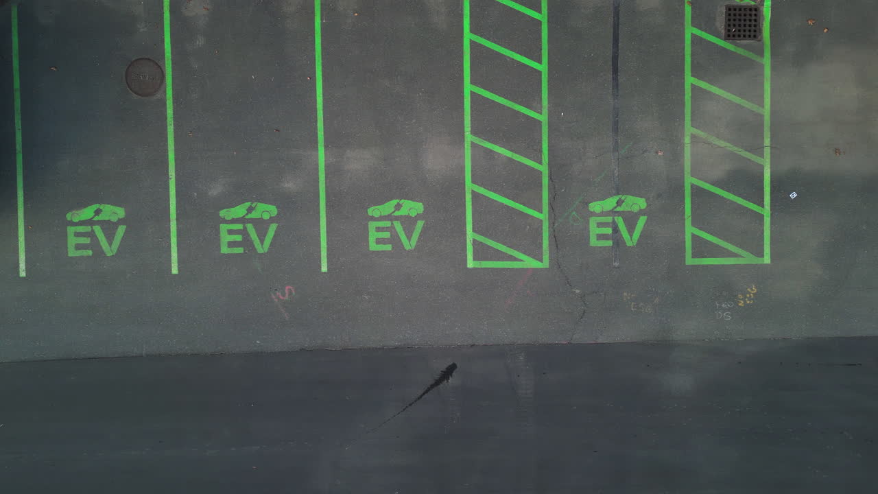 EV charging station parking spaces seen from above, marked in green, outdoors