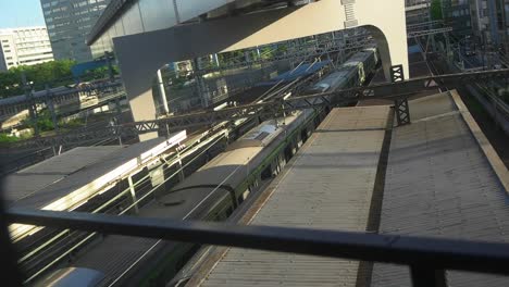 jr train passing between two railway platforms, view from above, japan