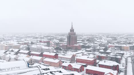 latvian academy of sciences during snowing foggy weather, riga, eastern europe