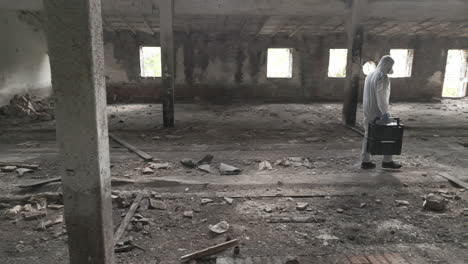 forensic scientist walks through an abandoned hall with