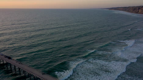 Aerial-footage-of-Scripps-Pier-La-Jolla-and-Blacks-Beach,-taken-during-sunset