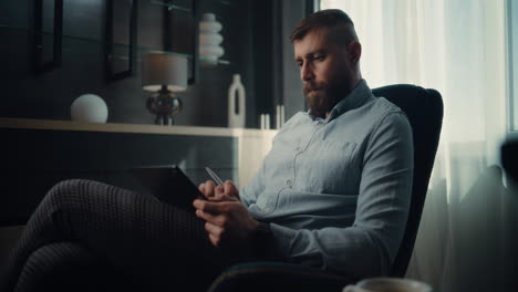 focused professional stock exchange broker monitoring real-time stocks and exchange market charts using laptop computer, making investments. successful investment agent working in modern home office.