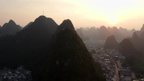 4k drone sunset above chinese city with mountains guilin yangshuo pan