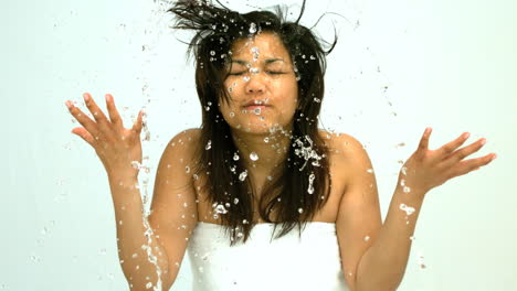 woman splashing water on her face