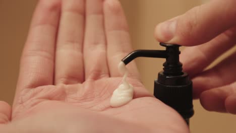 macro shot of hand cream being pumped out of a container