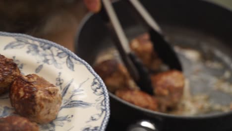 crop cook putting cutlets on plate