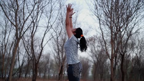 girls meditating practising yoga at sunset in forest padmasana slow motion