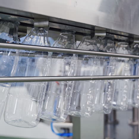 empty plastic bottles on conveyor line. bottle production line. plastic bottles for liquid products on conveyor belt in modern milk plant.