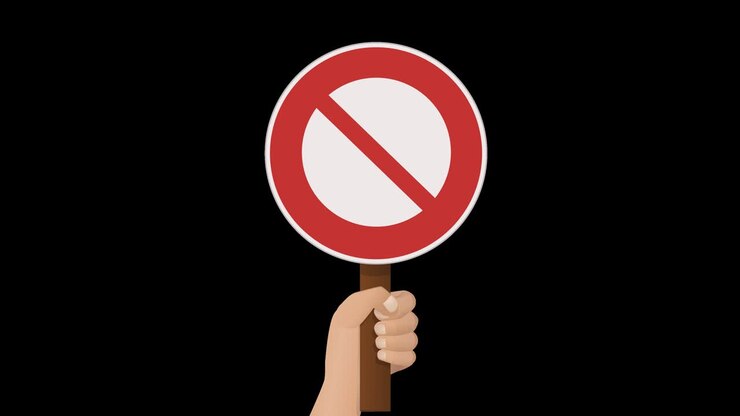 A hand holds up a prohibition sign with transparency alpha channel