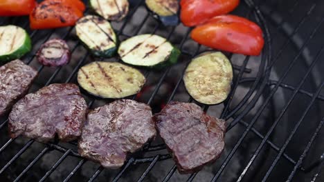 grilled steak and vegetables on a bbq