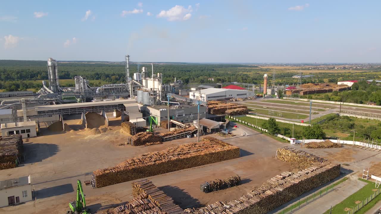 Aerial view of wood processing factory with stacks of lumber at plant manufacturing yard