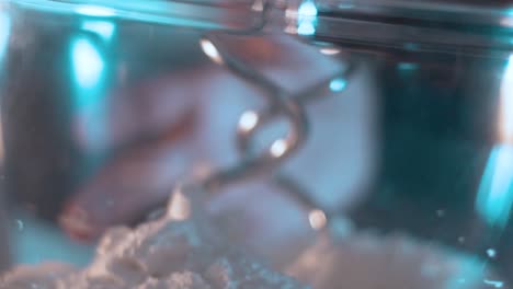 mixing whipped cream in a glass mixer