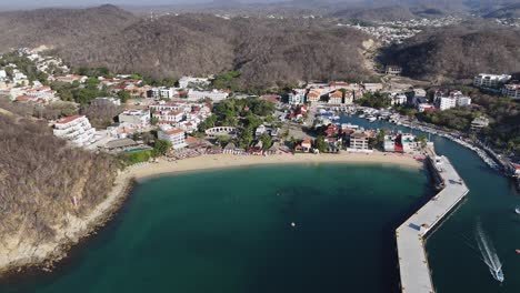 Birdseye-perspective-of-Huatulco-city,-captured-from-scenic-Santa-Cruz-Huatulco-Bay-in-Oaxaca