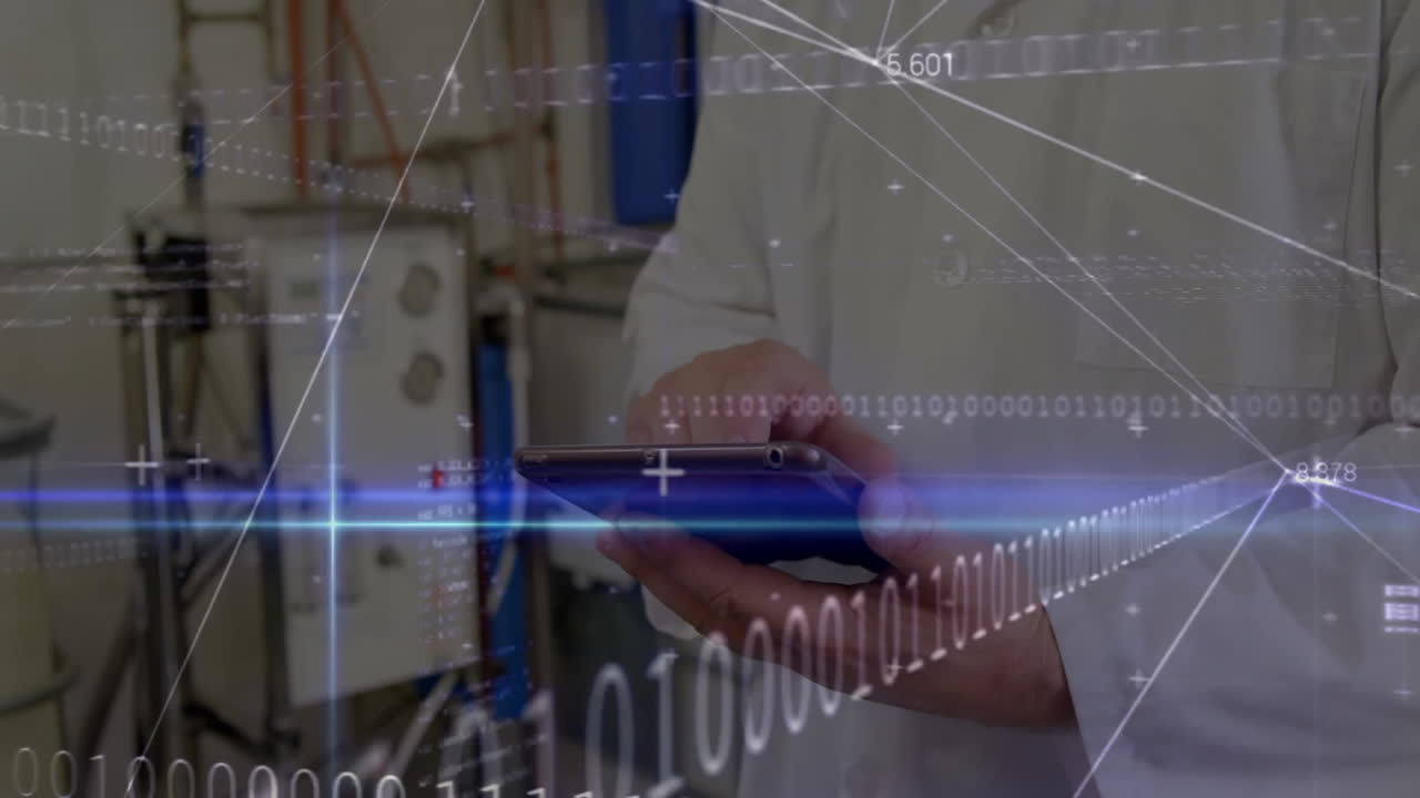 male engineer using handheld device in industrial lab, showing real-time data graphics
